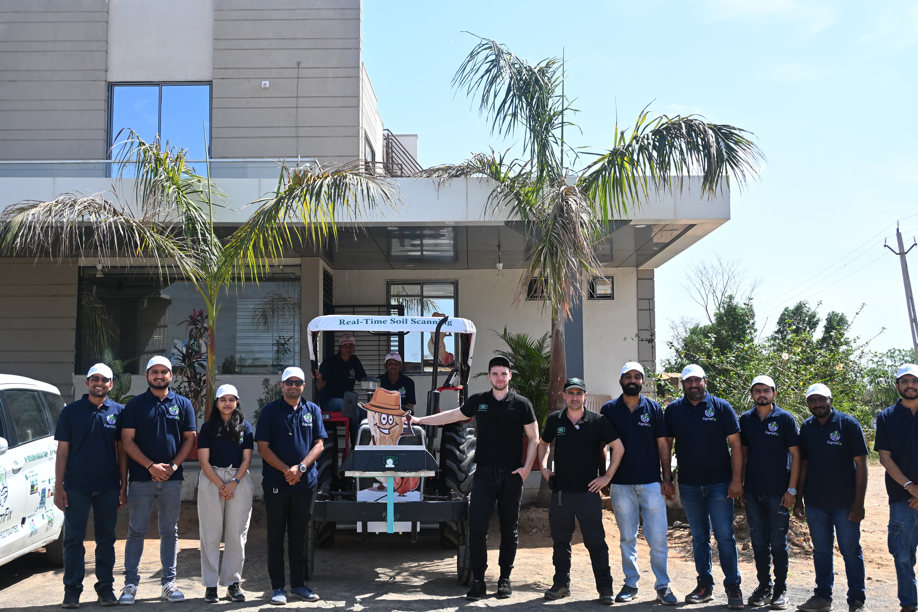 FarmFix team group with soil scanning tractor